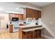 Charming kitchen featuring breakfast bar seating, wood cabinets, and modern appliances at 244 Angeles Rd, Debary, FL 32713