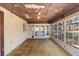 Enclosed sunroom featuring a ceiling fan, lots of windows, and a door to backyard at 244 Angeles Rd, Debary, FL 32713