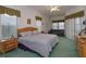 Spacious bedroom features a king bed, a comfortable couch, and natural light through the windows at 244 Ballyshannon Dr, Davenport, FL 33897