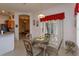 Cozy dining area with tile floors, slider to screened porch, and seating for four at 244 Ballyshannon Dr, Davenport, FL 33897