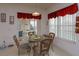 Bright dining area with a glass table, view of the backyard, and sliding door access at 244 Ballyshannon Dr, Davenport, FL 33897