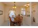Cozy dining room with table for six, chandelier, and view of backyard at 244 Ballyshannon Dr, Davenport, FL 33897