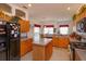 Open kitchen with wooden cabinets and countertops, connecting to the dining and living areas at 244 Ballyshannon Dr, Davenport, FL 33897
