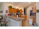 Functional kitchen with oak cabinets, granite counters, and island at 244 Ballyshannon Dr, Davenport, FL 33897