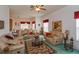 Bright living room featuring tan leather sofas, ceiling fan, and view into dining area at 244 Ballyshannon Dr, Davenport, FL 33897