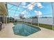 Refreshing screened-in pool surrounded by lush landscaping and patio space at 244 Ballyshannon Dr, Davenport, FL 33897