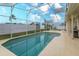 Relaxing screened-in pool area with clear blue water and ample patio space at 244 Ballyshannon Dr, Davenport, FL 33897