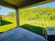 Covered patio looking out over a well maintained grassy backyard featuring a swing set at 2456 Varenna Loop, Kissimmee, FL 34741