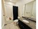 Bathroom features granite counters, a bathtub and shower combination with black fixtures at 2456 Varenna Loop, Kissimmee, FL 34741