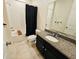 Bathroom features granite counters, a bathtub and shower combination with black fixtures at 2456 Varenna Loop, Kissimmee, FL 34741