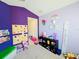 Playroom featuring carpet, climbing wall, educational wall art and colorful unicorn decor at 2456 Varenna Loop, Kissimmee, FL 34741