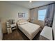 Cozy bedroom with soft color scheme, white furniture, and natural light through the window at 2456 Varenna Loop, Kissimmee, FL 34741