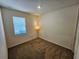 Carpeted bedroom features a lamp and window providing light to the space at 2456 Varenna Loop, Kissimmee, FL 34741