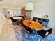 Dining area with wood table and chairs next to kitchen, complemented by a decorative area rug at 2456 Varenna Loop, Kissimmee, FL 34741