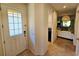 Bright foyer features a tiled floor and a front door with decorative glass at 2456 Varenna Loop, Kissimmee, FL 34741