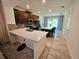 Spacious open-concept kitchen featuring stainless steel appliances and center island with seating at 2456 Varenna Loop, Kissimmee, FL 34741