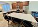 Open concept kitchen with stainless appliances, mosaic backsplash and large island seating area at 2456 Varenna Loop, Kissimmee, FL 34741