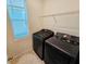 Well lit laundry room featuring front load washer and dryer with overhead storage shelf at 2456 Varenna Loop, Kissimmee, FL 34741