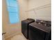 Well lit laundry room featuring front load washer and dryer with overhead storage shelf at 2456 Varenna Loop, Kissimmee, FL 34741