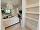 Bright living room featuring tiled floors, white sofa, and built in shelving at 2456 Varenna Loop, Kissimmee, FL 34741