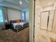Beautiful bedroom with large window and view into the attached bathroom featuring a walk in shower at 2456 Varenna Loop, Kissimmee, FL 34741