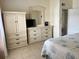 Bedroom with a dresser, mirror, TV, and access to a closet, offering ample storage space at 2514 Citrus Club Ln # 308, Orlando, FL 32839