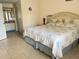 Comfortable bedroom featuring a large bed with floral bedding and an adjoining bathroom at 2514 Citrus Club Ln # 308, Orlando, FL 32839