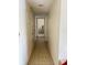 Straight hallway with tile flooring leading to bedroom with dresser at 2514 Citrus Club Ln # 308, Orlando, FL 32839