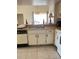 Bright kitchen with a double sink, dishwasher, and white cabinets and appliances at 2514 Citrus Club Ln # 308, Orlando, FL 32839
