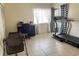 Versatile living space with a treadmill, desk, and ample natural light from the window at 2514 Citrus Club Ln # 308, Orlando, FL 32839