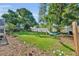 Well-maintained backyard with lush grass, palm trees, privacy fence and a relaxing hammock at 2524 Sweetwater Trl, Winter Park, FL 32789
