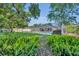 Expansive backyard with a screened pool, privacy fence, lush greenery, and space for outdoor activities at 2524 Sweetwater Trl, Winter Park, FL 32789