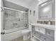 This bathroom features a tub and shower combo with tiled surround, a modern vanity, and elegant fixtures at 2524 Sweetwater Trl, Winter Park, FL 32789