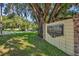 The Hills of Winter Park sign displayed on a brick wall, shaded by a mature oak tree at 2524 Sweetwater Trl, Winter Park, FL 32789