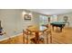 Dining area features wood floors and seating for four with backyard views at 2524 Sweetwater Trl, Winter Park, FL 32789