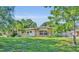 Charming single-story home with well-manicured lawn, stone accents, and welcoming front entrance at 2524 Sweetwater Trl, Winter Park, FL 32789