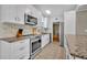 Modern kitchen with stainless steel appliances, granite countertops, and stylish backsplash for culinary enthusiasts at 2524 Sweetwater Trl, Winter Park, FL 32789