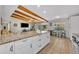 Bright kitchen with granite countertops, island seating, and open access to the adjacent living area at 2524 Sweetwater Trl, Winter Park, FL 32789