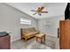 Cozy living room with tile floors and a comfortable futon, perfect for relaxing or entertaining guests at 2524 Sweetwater Trl, Winter Park, FL 32789