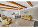 Open-concept living room featuring exposed beams, tile flooring, and a kitchen with a center island at 2524 Sweetwater Trl, Winter Park, FL 32789