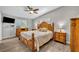 Comfortable main bedroom featuring hardwood floors, a ceiling fan, and ample natural light at 2524 Sweetwater Trl, Winter Park, FL 32789