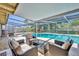 Inviting screened-in pool area with comfortable seating, perfect for outdoor relaxation and entertainment at 2524 Sweetwater Trl, Winter Park, FL 32789