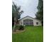 Backyard view of home featuring a large screened in porch and well manicured lawn at 300 Churchill Dr, Longwood, FL 32779