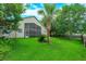 Backyard view of the screened in lanai and lush green landscaping at 300 Churchill Dr, Longwood, FL 32779