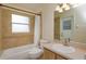 Bathroom featuring tile surround tub, neutral paint, and vanity at 300 Churchill Dr, Longwood, FL 32779