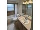 A bright bathroom features a tub, tile flooring, and a vanity sink for everyday convenience at 300 Churchill Dr, Longwood, FL 32779