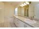 Bathroom with double sinks, granite countertops, tiled floors, and soaking tub at 300 Churchill Dr, Longwood, FL 32779