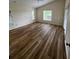 Comfortable bedroom features wood-look floors and natural lighting at 300 Churchill Dr, Longwood, FL 32779