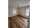 A well-lit bedroom with hardwood floors and a ceiling fan provides comfort and style at 300 Churchill Dr, Longwood, FL 32779
