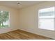 Bedroom featuring neutral paint, wood floors, ceiling fan, and large windows at 300 Churchill Dr, Longwood, FL 32779